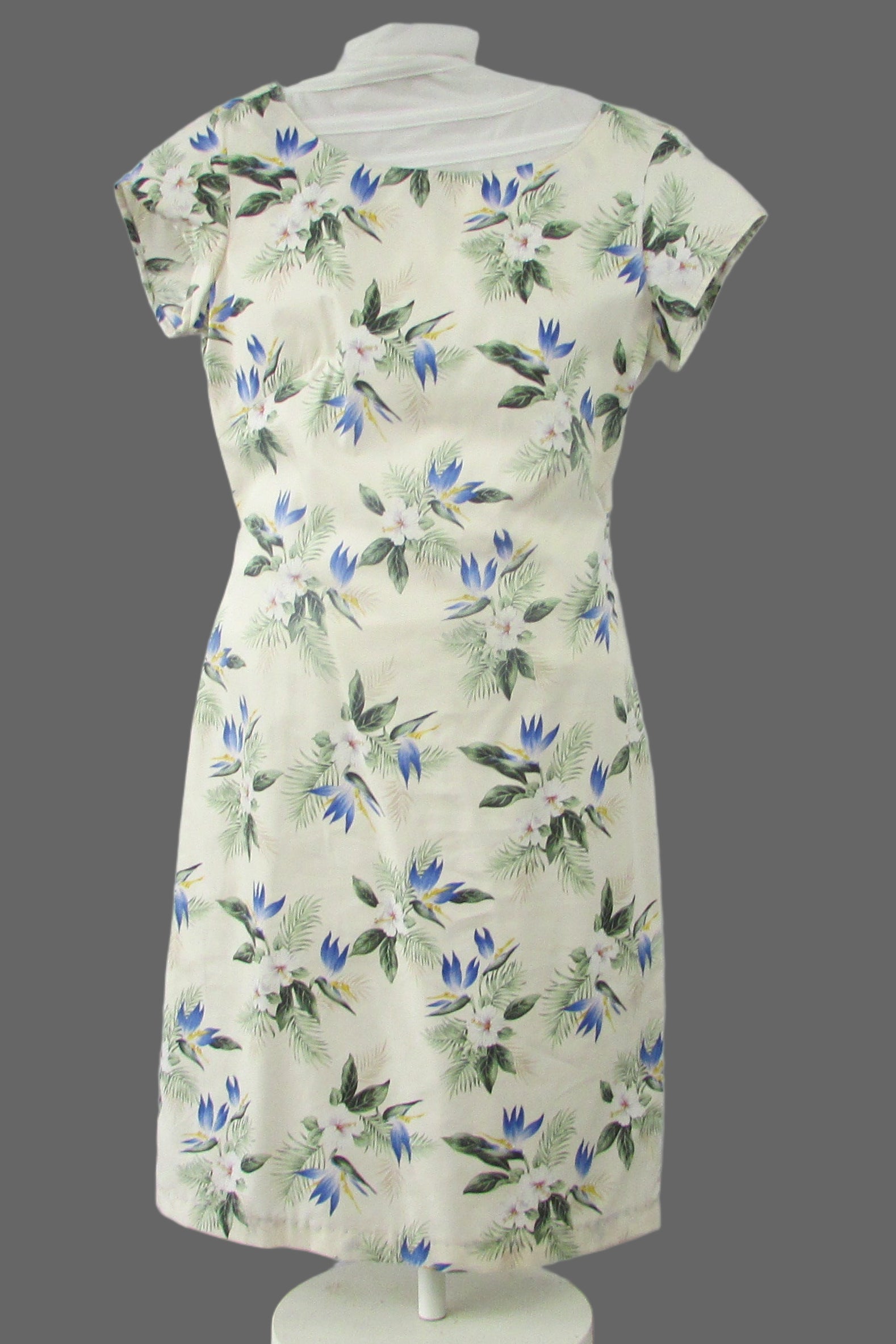 Floral dress on a mannequin against a white backdrop